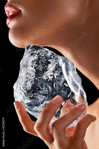Photo: Woman holding ice to neck. Woman holding ice to neck.