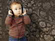 portrait of a handsome kid listening to music looking up against