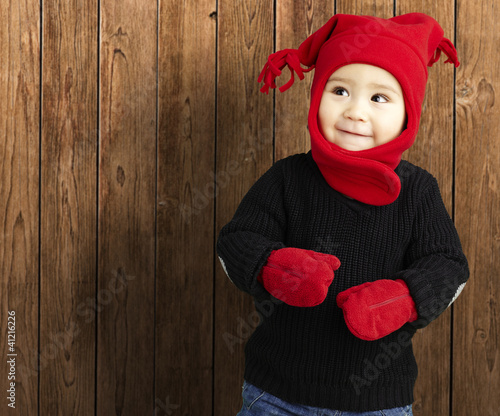 Photo: portrait of an adorable kid smiling wearing winter clothes again portrait of an adorable kid smiling wearing winter clothes again