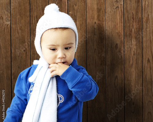 Photo: portrait of serious kid thinking with the finger on his mouth ag portrait of serious kid thinking with the finger on his mouth ag