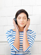 happy teenage girl in big headphones