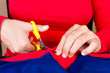 Hands cutting a piece of fabric to make clothes Hands cutting a piece of fabric to make clothes