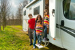 Family vacation trip. Parents with kids travel on camper (RV)