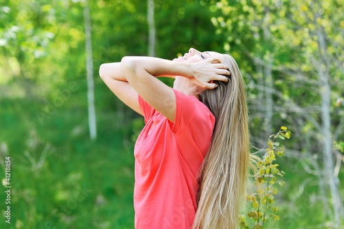 Photo: Beautiful young woman enjoys relaxing with eyes closed Beautiful young woman enjoys relaxing with eyes closed