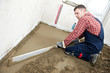 Plasterer concrete worker at floor work