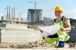 Engineer builders at construction site with draft