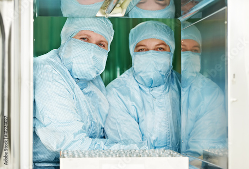Photo: Two pharmaceutical factory workers Two pharmaceutical factory workers