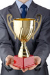 Man being awarded with golden cup