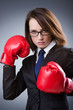 Young businesswoman in boxing concept