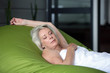 canvas print picture - Old woman asleep on large bean-bag