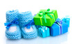 beautiful gifts and baby's bootees isolated on white