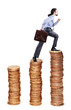 Businessman climbing gold coins stacks Businessman climbing gold coins stacks