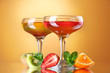 fruit jelly in glasses and fruits on yellow background fruit jelly in glasses and fruits on yellow background