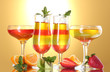 fruit jelly in glasses and fruits on yellow background fruit jelly in glasses and fruits on yellow background