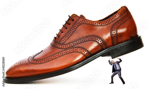 Photo: Woman domination concept with shoes and man Woman domination concept with shoes and man