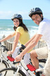Young man and young woman having bike ride Young man and young woman having bike ride