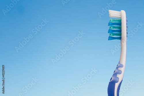 Photo: toothbrush on blue background toothbrush on blue background