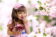 little girl with cherry berries bowl in garden