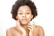 Lovely ethnic woman applying face cream or moisturizer