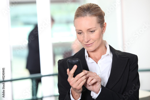 Photo: Woman dialing phone number Woman dialing phone number