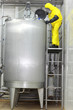 canvas print picture - technician controlling industrial process in factory