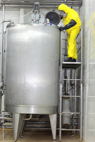 Photo: technician controlling industrial process in factory technician controlling industrial process in factory