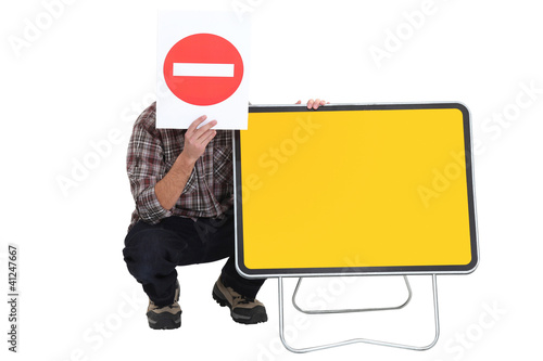Photo: Worker with blank road sign Worker with blank road sign