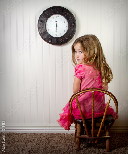 Photo: little girl in time out or in trouble looking little girl in time out or in trouble looking