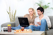 Couple eating breakfast on sofa Couple eating breakfast on sofa