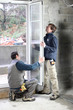 carpenter and younger apprentice at wok