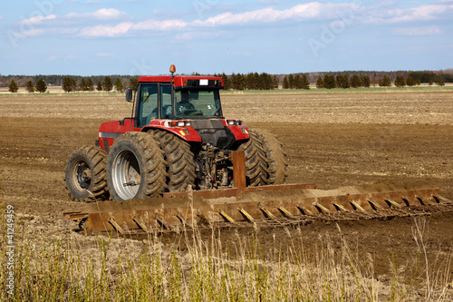 Photo: Tractor cultivated field Tractor cultivated field