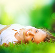 Spring Girl lying on the Field. Happiness