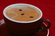 Coffee beans swims on cappuccino surface in cup Coffee beans swims on cappuccino surface in cup