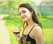 Red wine. Woman drinking red wine outdoor on nature green backgr Red wine. Woman drinking red wine outdoor on nature green backgr