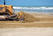 bulldozer in the sand near the sea bulldozer in the sand near the sea