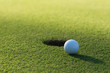 A golf ball and hole