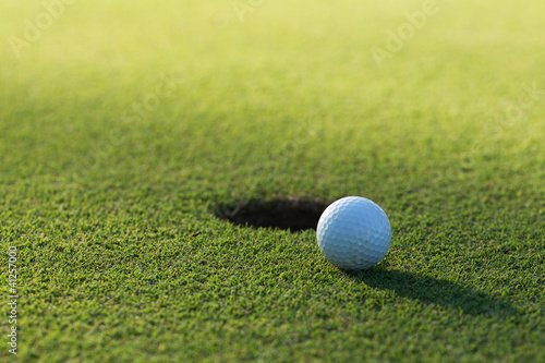Photo: A golf ball and hole A golf ball and hole