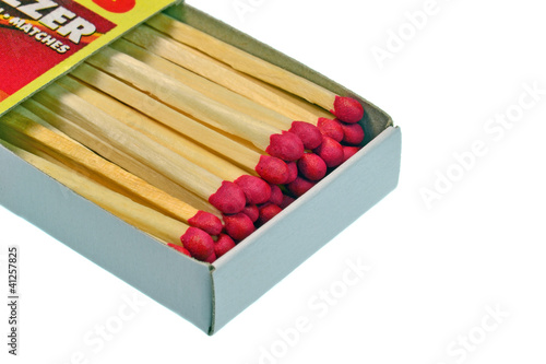 Photo: An open box of matches on a white background An open box of matches on a white background