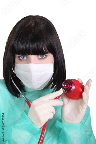 Photo: Doctor listening to a plastic heart with a stethoscope Doctor listening to a plastic heart with a stethoscope