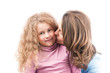 Mother kissing happy little daughter.