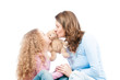 Mother and daughter kissing teddy bear.