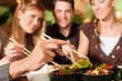 Young people eating in Thai restaurant