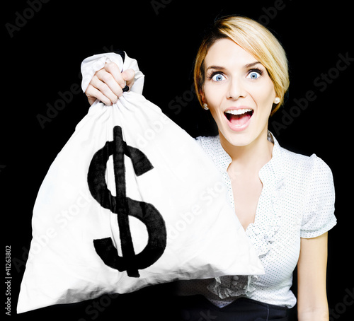 Photo: Euphoric business woman holding unexpected windfall Euphoric business woman holding unexpected windfall