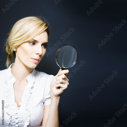 Photo: Stylish business woman with magnifying glass Stylish business woman with magnifying glass