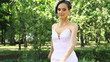 Lady in white whirling and scattering rose petals