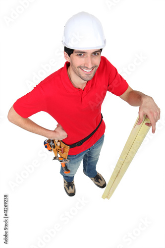 Photo: Casual carpenter stood with timber Casual carpenter stood with timber