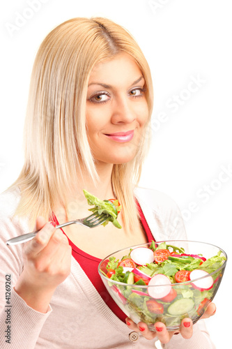 Photo: Young woman eating salad Young woman eating salad