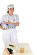 canvas print picture - female diy enthusiast holding wallpaper rolls