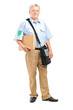 Full length portrait of a mature postman delivering a box