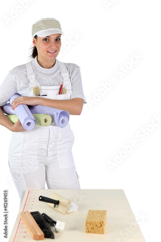 Photo: female diy enthusiast holding wallpaper rolls female diy enthusiast holding wallpaper rolls